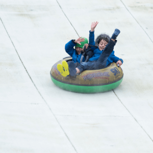 Two children tubing at The Hill - Ski Rossendale